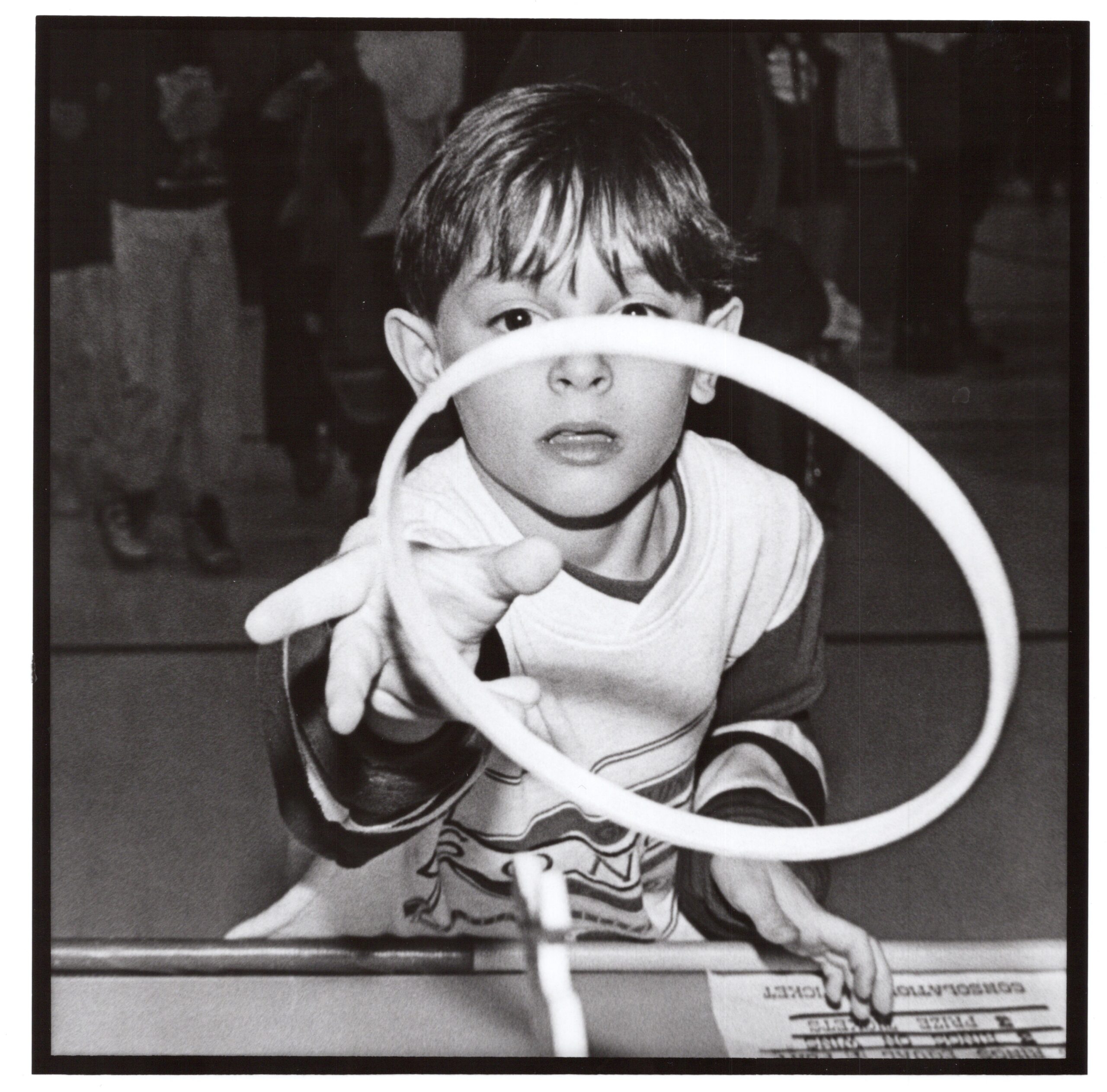 Boy playing ring toss.