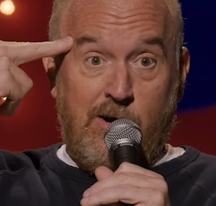Louis CK performing standup comedy.