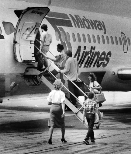 People in 1960s boarding a plane.